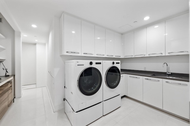 laundry room with washing machine and dryer, a sink, recessed lighting, and light tile patterned flooring