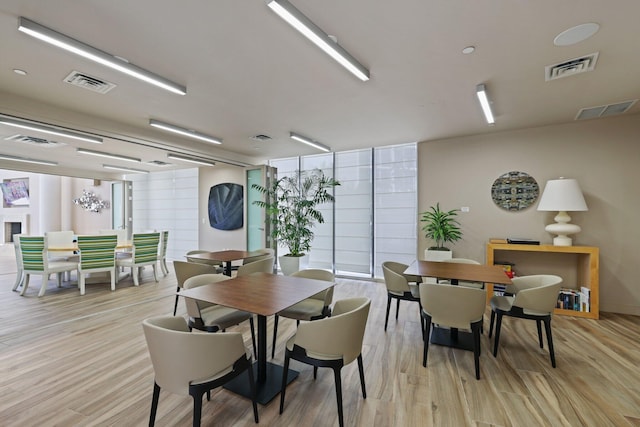 dining space featuring light wood-style floors and visible vents