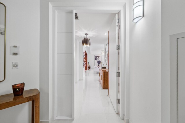 corridor with light tile patterned flooring