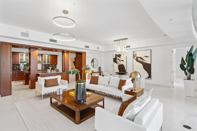 living room featuring visible vents, an inviting chandelier, and light tile patterned floors