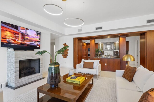 living area with a premium fireplace and visible vents