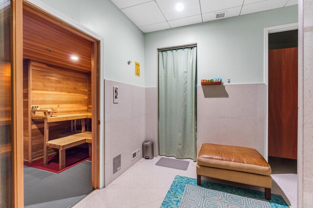 1600 S Ocean Blvd Unit Mph02, Lauderdale By The Sea, FL 33062 - bathroom featuring a relaxing sauna, a wainscoted wall, tile walls, and tile patterned floors
