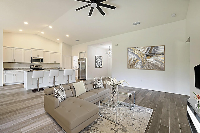 17854 N 71st Ln N, The Acreage, FL 33470 - living room with ceiling fan, light wood-style floors, recessed lighting, high vaulted ceiling, and baseboards
