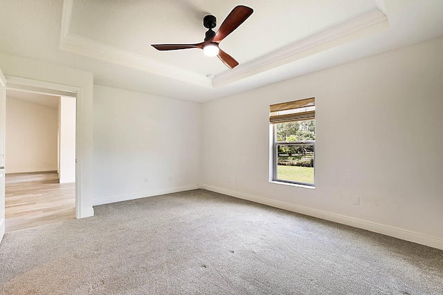 17854 N 71st Ln N, The Acreage, FL 33470 - unfurnished room with a raised ceiling, crown molding, light carpet, a ceiling fan, and baseboards