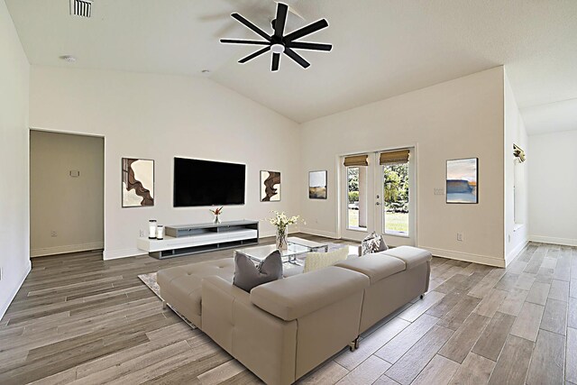 17854 N 71st Ln N, The Acreage, FL 33470 - living room with ceiling fan, wood finished floors, baseboards, and high vaulted ceiling