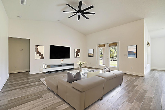 17854 N 71st Ln N, The Acreage, FL 33470 - living room with ceiling fan, wood finished floors, baseboards, and high vaulted ceiling