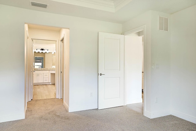 17854 N 71st Ln N, The Acreage, FL 33470 - unfurnished bedroom featuring light colored carpet, baseboards, and ensuite bath