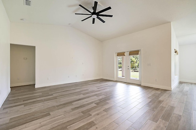 17854 N 71st Ln N, The Acreage, FL 33470 - unfurnished room featuring a ceiling fan, light wood finished floors, lofted ceiling, baseboards, and french doors