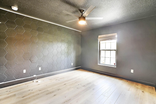 17854 N 71st Ln N, The Acreage, FL 33470 - spare room with ceiling fan, hardwood / wood-style floors, a textured ceiling, and baseboards