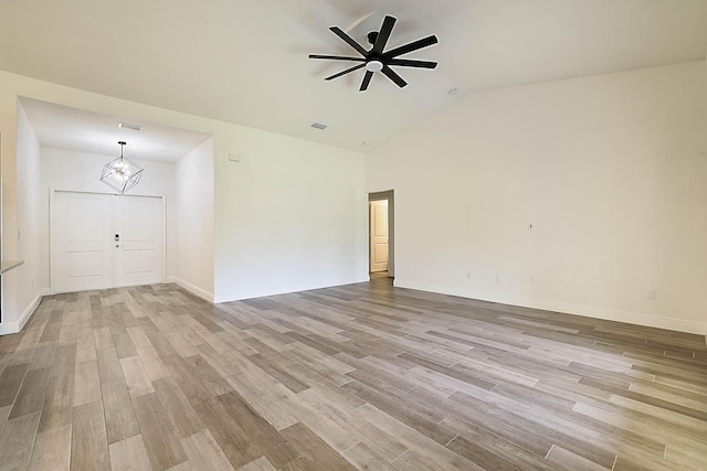 17854 N 71st Ln N, The Acreage, FL 33470 - unfurnished room featuring a ceiling fan, wood finished floors, a chandelier, baseboards, and high vaulted ceiling