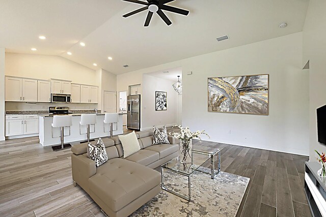 17854 N 71st Ln N, The Acreage, FL 33470 - living room featuring ceiling fan, light wood-style floors, recessed lighting, high vaulted ceiling, and baseboards