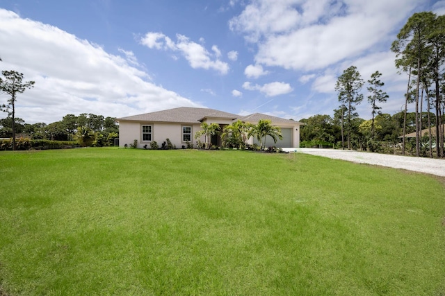 17854 N 71st Ln N, The Acreage, FL 33470 - view of front of property featuring a front yard, stucco siding, gravel driveway, and a garage
