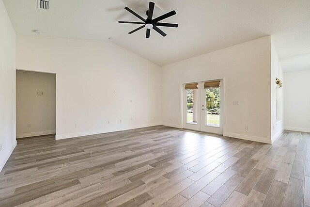 17854 N 71st Ln N, The Acreage, FL 33470 - unfurnished room featuring a ceiling fan, light wood finished floors, lofted ceiling, baseboards, and french doors