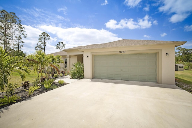 17854 N 71st Ln N, The Acreage, FL 33470 - view of front of house with concrete driveway, stucco siding, and a garage
