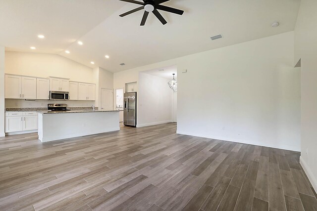 17854 N 71st Ln N, The Acreage, FL 33470 - unfurnished living room featuring ceiling fan, light wood-type flooring, recessed lighting, high vaulted ceiling, and baseboards