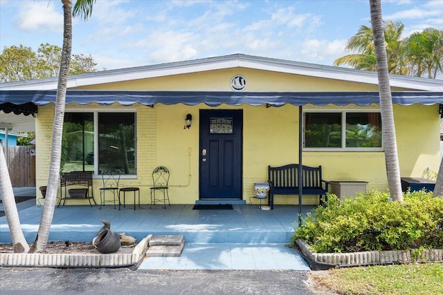 265 NE 13th St, Delray Beach, FL 33444 - view of front of property featuring a porch and stucco siding