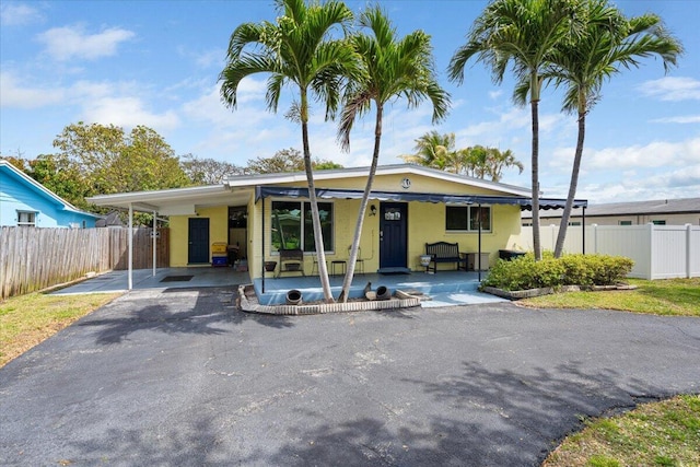 265 NE 13th St, Delray Beach, FL 33444 - view of front of property featuring driveway, an attached carport, and a porch
