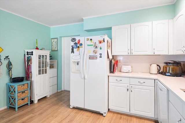 265 NE 13th St, Delray Beach, FL 33444 - kitchen with white appliances, ornamental molding, white cabinetry, light wood-style flooring, and light countertops
