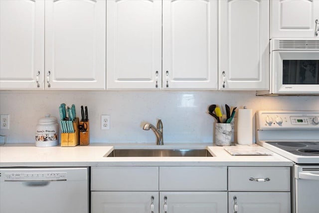 265 NE 13th St, Delray Beach, FL 33444 - kitchen featuring white appliances, a sink, white cabinetry, and light countertops