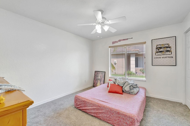 carpeted bedroom featuring baseboards and ceiling fan