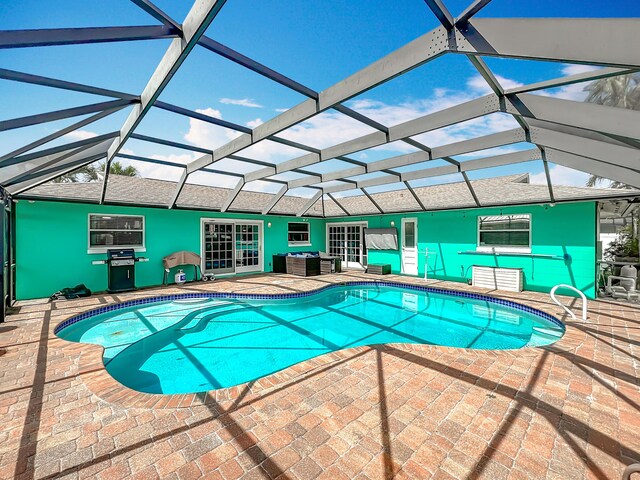 178 Via De La Reina, Merritt Island, FL 32953 - outdoor pool featuring a patio area, outdoor lounge area, glass enclosure, and a grill