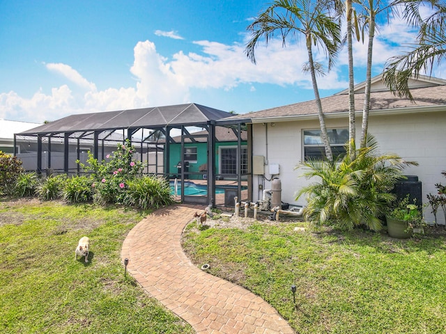 178 Via De La Reina, Merritt Island, FL 32953 - back of house with an outdoor pool, concrete block siding, and a lawn