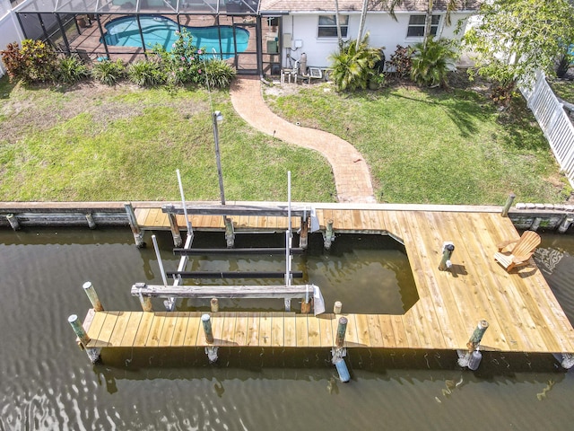 178 Via De La Reina, Merritt Island, FL 32953 - view of dock featuring boat lift, an outdoor pool, a water view, a lawn, and a fenced backyard