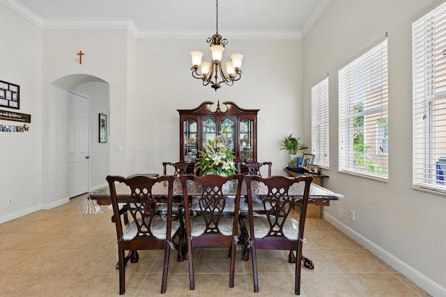 707 Cresta Cir, West Palm Beach, FL 33413 - dining area featuring ornamental molding, baseboards, a chandelier, arched walkways, and light tile patterned floors