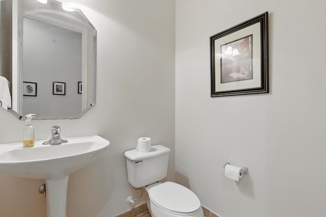 707 Cresta Cir, West Palm Beach, FL 33413 - bathroom featuring baseboards and toilet