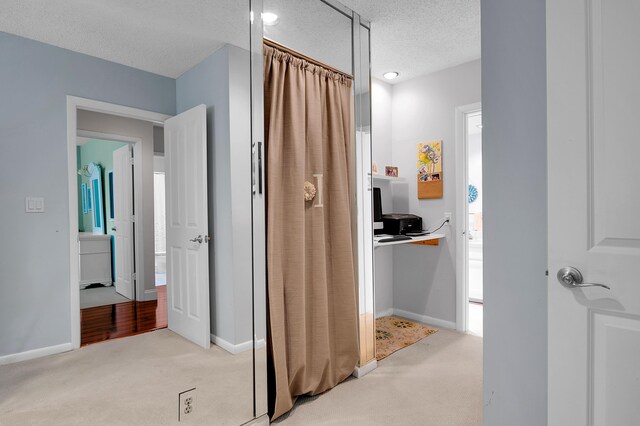 6117 Old Court Rd Unit 135, Boca Raton, FL 33433 - hallway with baseboards, a textured ceiling, and light colored carpet
