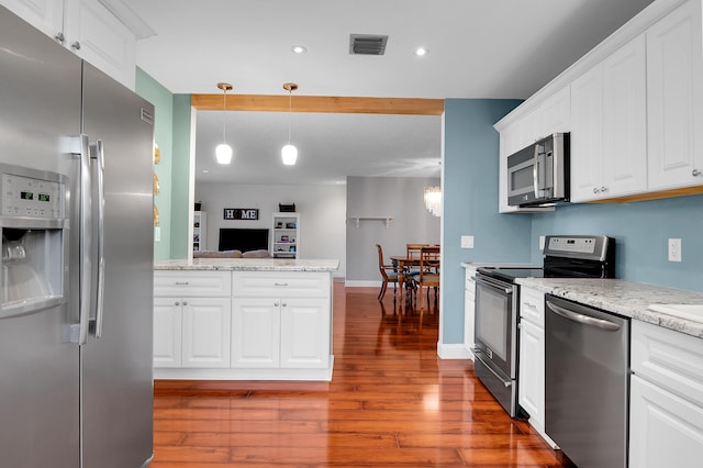 6117 Old Court Rd Unit 135, Boca Raton, FL 33433 - kitchen with stainless steel appliances, a peninsula, visible vents, white cabinetry, and wood finished floors
