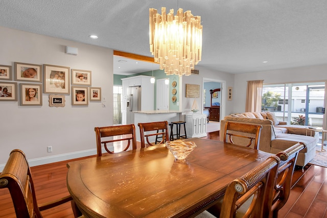 6117 Old Court Rd Unit 135, Boca Raton, FL 33433 - dining area featuring a textured ceiling, baseboards, a notable chandelier, dark wood-type flooring, and recessed lighting