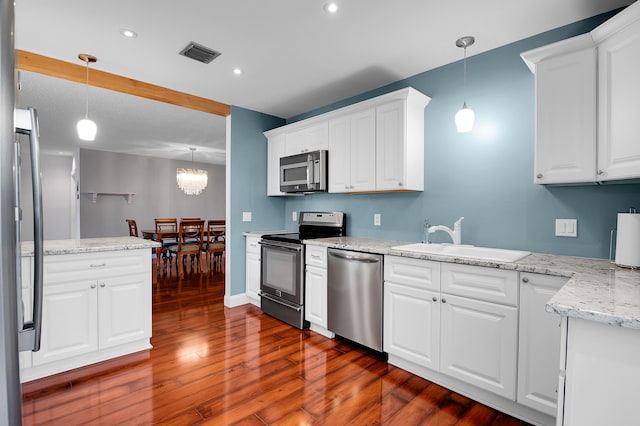 6117 Old Court Rd Unit 135, Boca Raton, FL 33433 - kitchen with white cabinets, dark wood-style floors, a sink, visible vents, and appliances with stainless steel finishes
