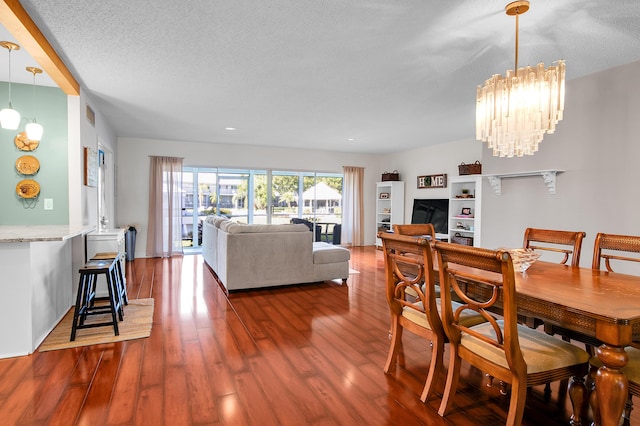 6117 Old Court Rd Unit 135, Boca Raton, FL 33433 - dining space with a textured ceiling, wood finished floors, recessed lighting, and a notable chandelier