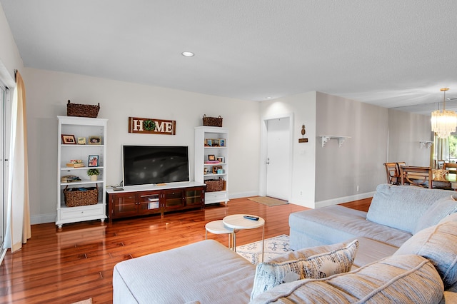 6117 Old Court Rd Unit 135, Boca Raton, FL 33433 - living room featuring wood finished floors, a textured ceiling, an inviting chandelier, baseboards, and recessed lighting