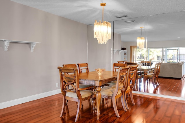 6117 Old Court Rd Unit 135, Boca Raton, FL 33433 - dining area with baseboards, hardwood / wood-style flooring, and a notable chandelier