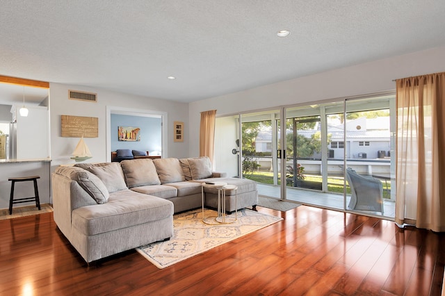 6117 Old Court Rd Unit 135, Boca Raton, FL 33433 - living area with wood-type flooring, a textured ceiling, and visible vents