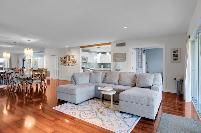 6117 Old Court Rd Unit 135, Boca Raton, FL 33433 - living room with an inviting chandelier, wood finished floors, visible vents, and baseboards