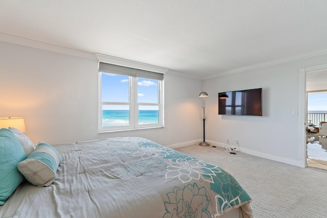bedroom with crown molding, baseboards, and carpet flooring