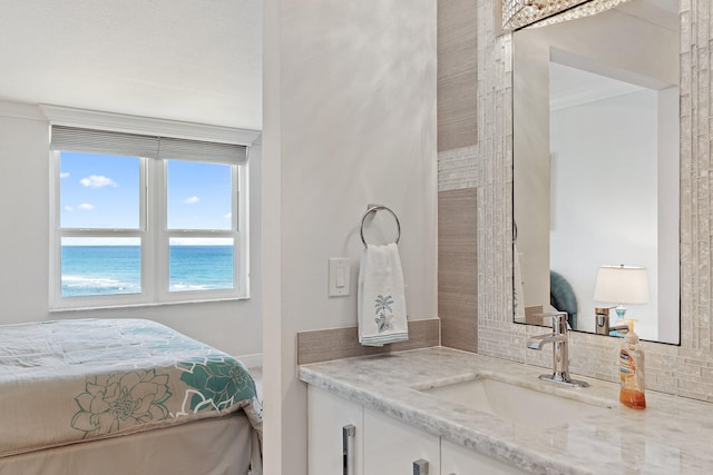interior space featuring vanity, a water view, and backsplash