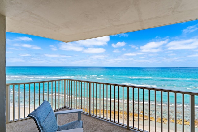 balcony with a view of the beach and a water view