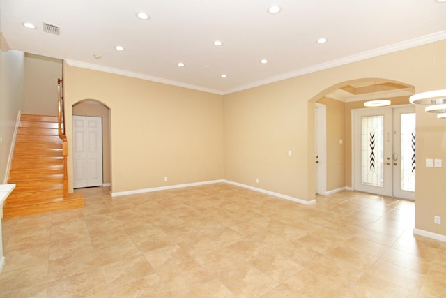 unfurnished room with arched walkways, visible vents, crown molding, and baseboards