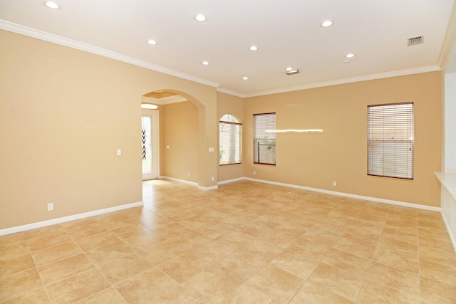 empty room with visible vents, arched walkways, recessed lighting, and crown molding