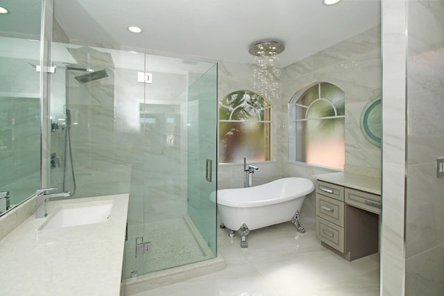 full bath featuring a freestanding bath, vanity, a stall shower, and recessed lighting
