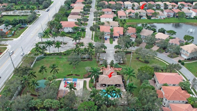drone / aerial view with a water view and a residential view