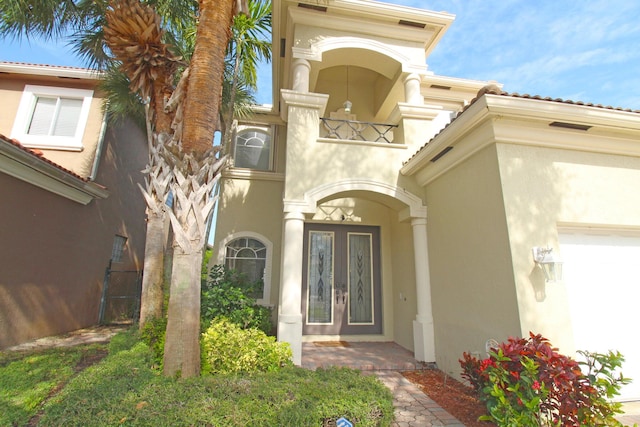 doorway to property featuring french doors and stucco siding