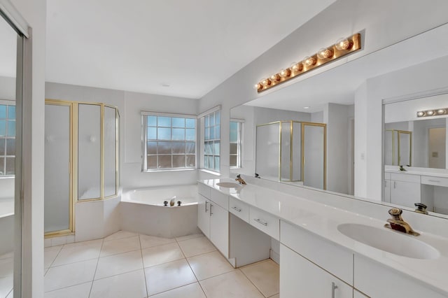 bathroom featuring a sink, double vanity, a shower stall, and a garden tub