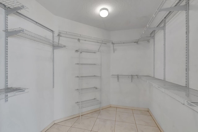 spacious closet featuring tile patterned flooring