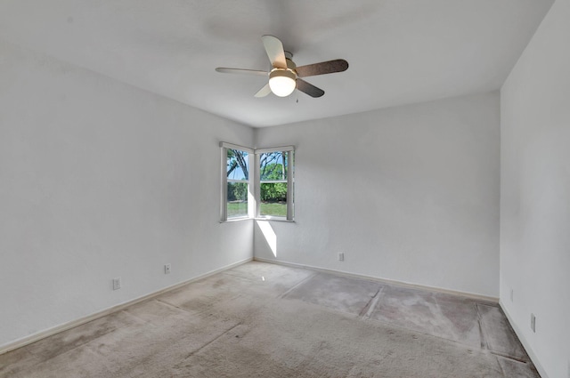 spare room featuring baseboards, carpet flooring, and ceiling fan