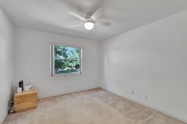 empty room featuring carpet flooring and ceiling fan